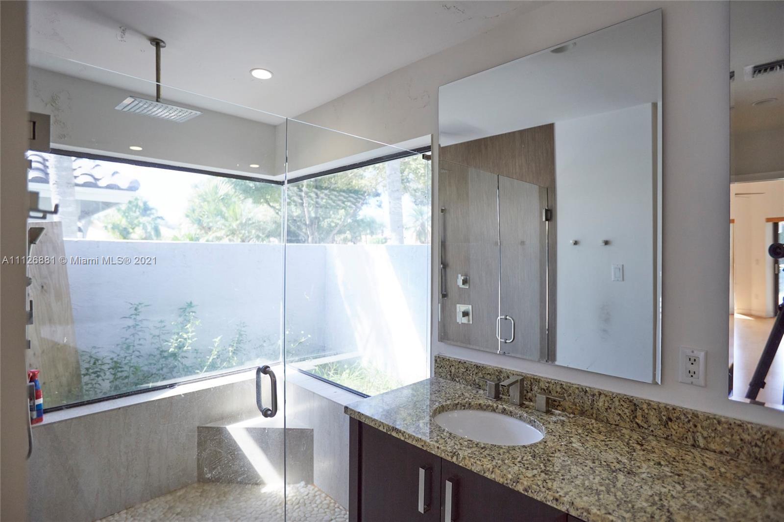 10726 Santa Rosa Drive Boca Raton, FL 33498 - Photo 17 of 26 a bathroom with a granite countertop sink mirror vanity bathtub and window