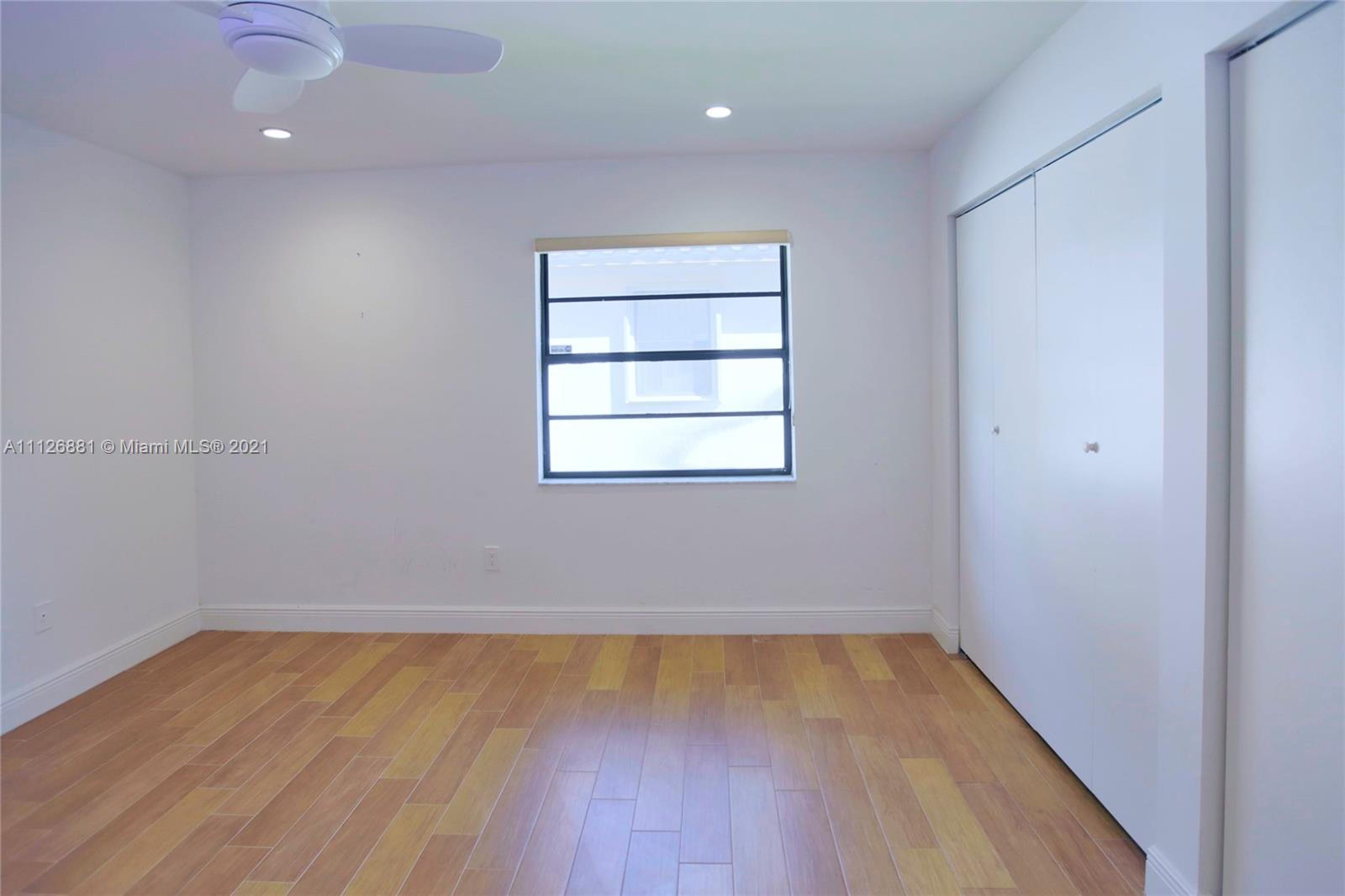 10726 Santa Rosa Drive Boca Raton, FL 33498 - Photo 20 of 26 wooden floor in an empty room with a window