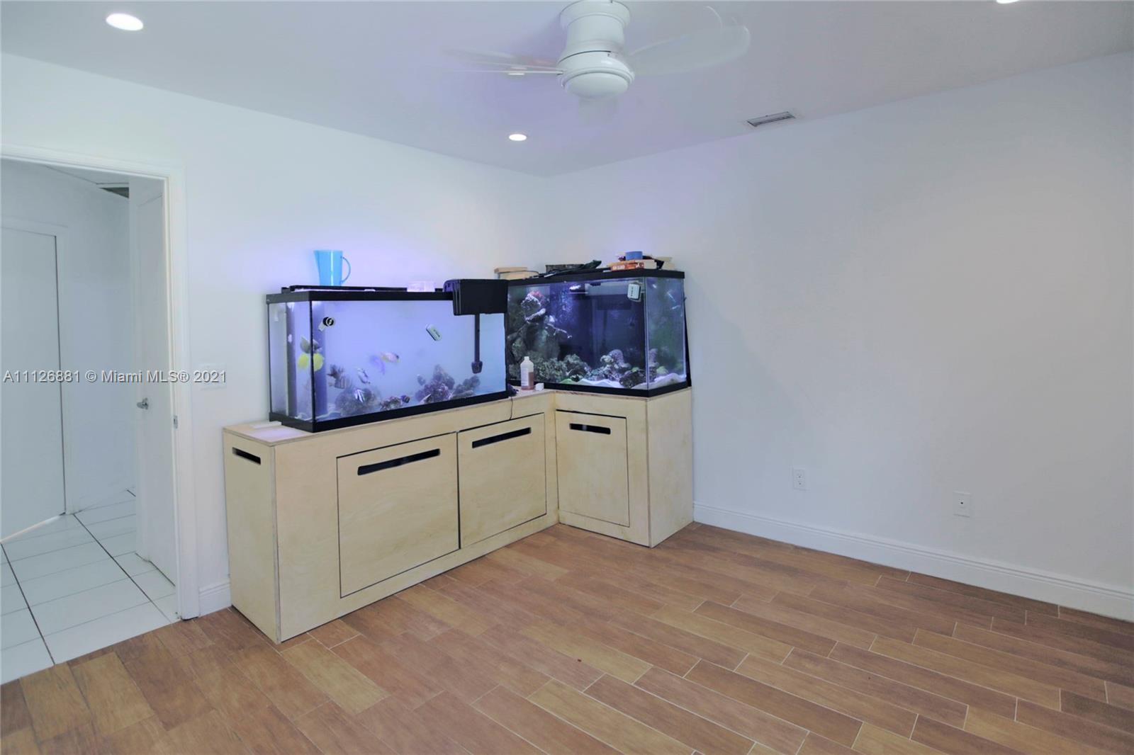 10726 Santa Rosa Drive Boca Raton, FL 33498 - Photo 21 of 26 a view of cabinets with wooden floor