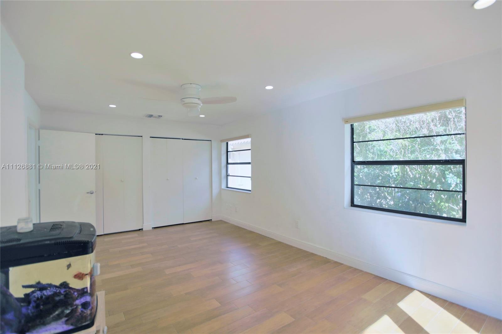 10726 Santa Rosa Drive Boca Raton, FL 33498 - Photo 23 of 26 a view of a livingroom with wooden floor and a window