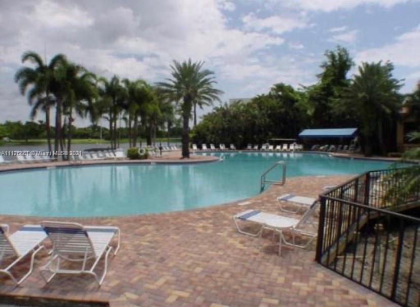 10726 Santa Rosa Drive Boca Raton, FL 33498 - Photo 26 of 26 a view of a lake with a yard and palm trees