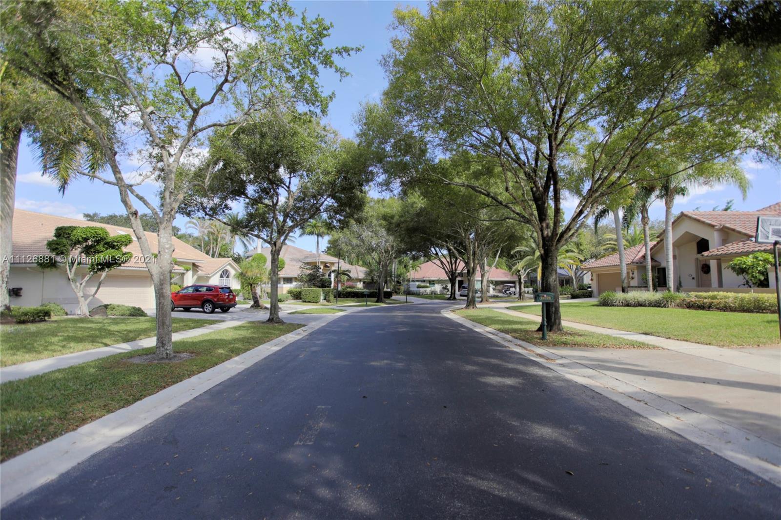 10726 Santa Rosa Drive Boca Raton, FL 33498 - Photo 5 of 26 a view of street with houses and trees
