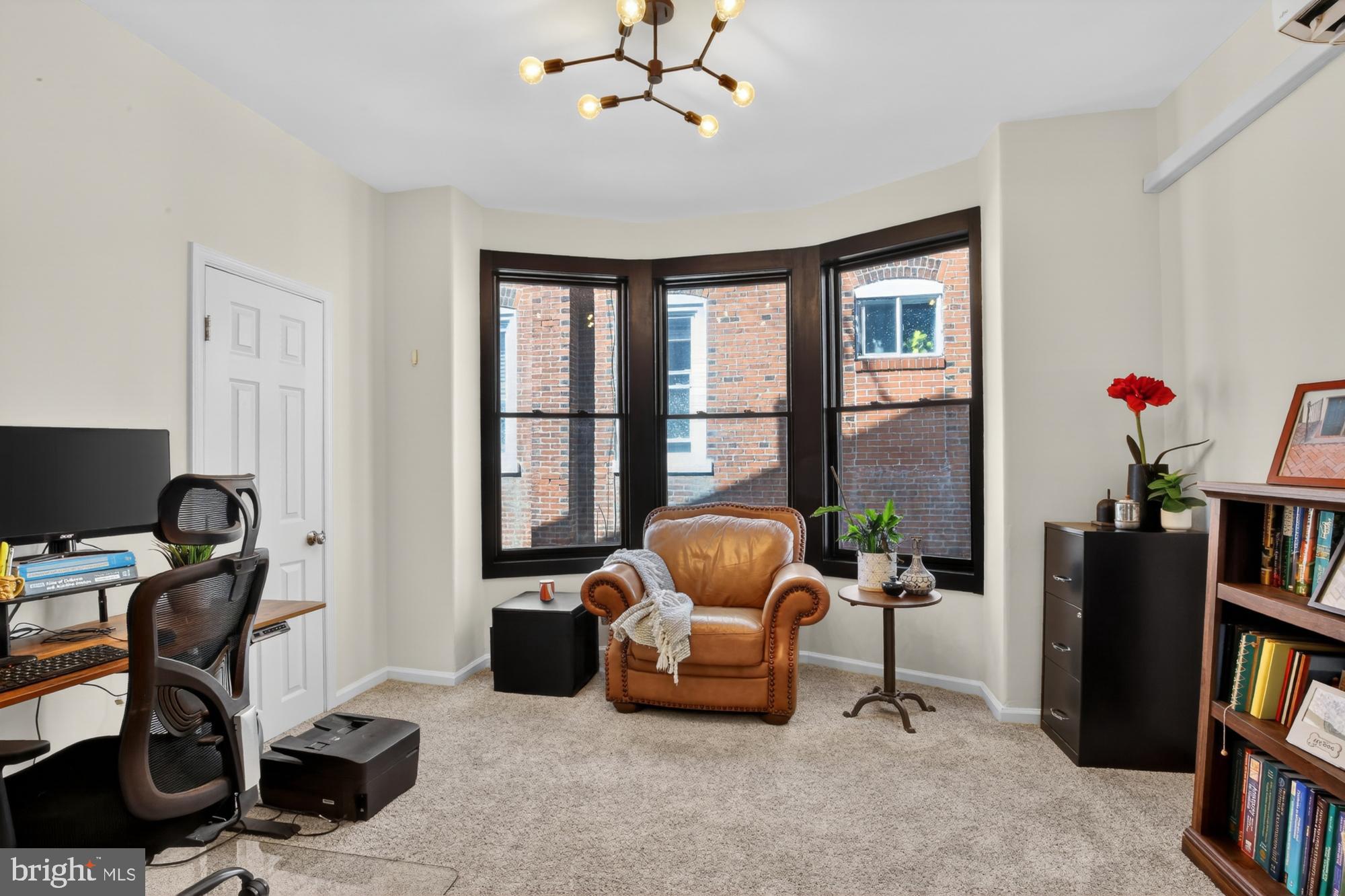 4315 Lauriston Street Philadelphia, PA 19128 - Photo 25 of 43 a living room with furniture a bookshelf and a window