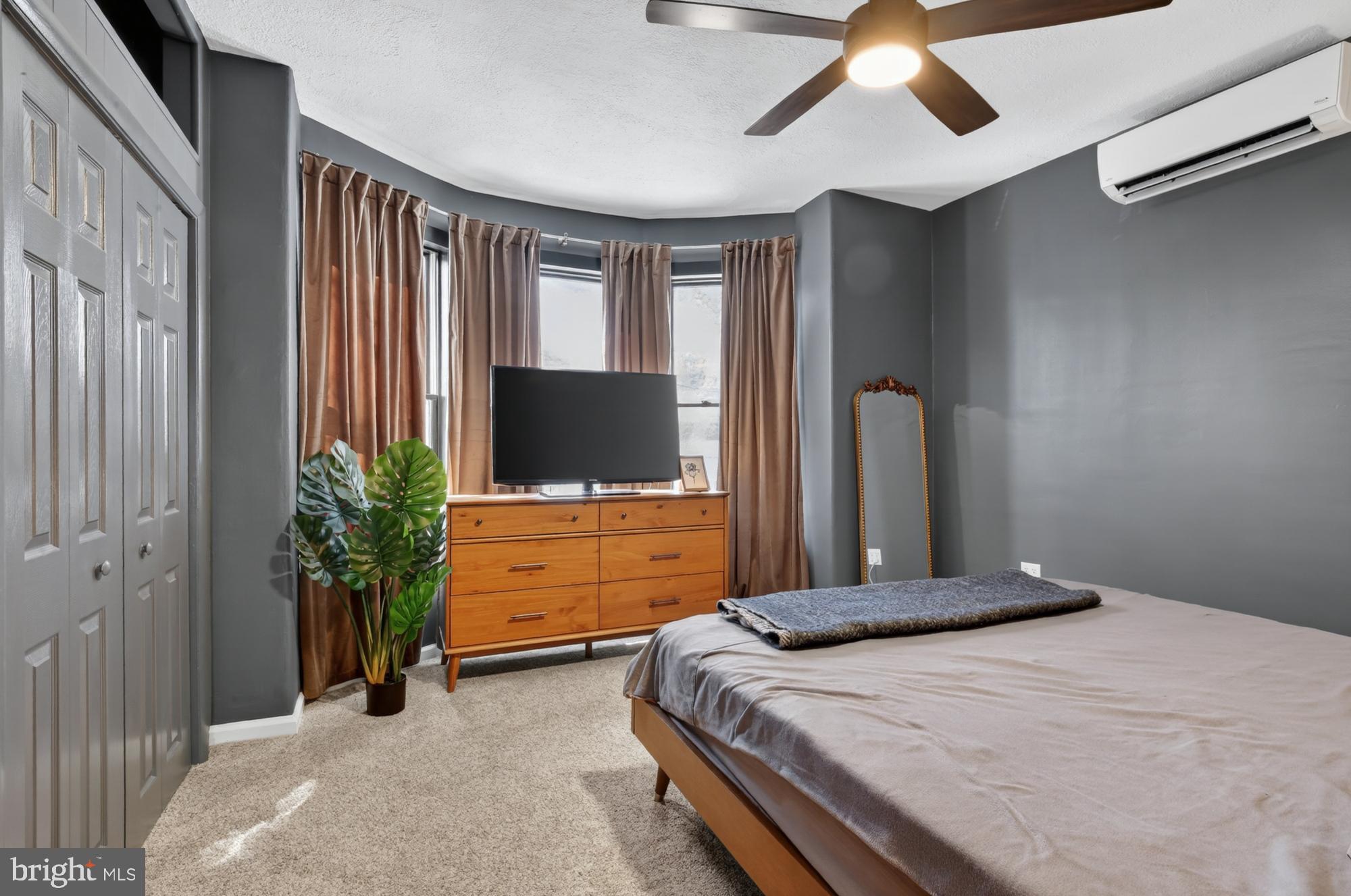 4315 Lauriston Street Philadelphia, PA 19128 - Photo 28 of 43 a bedroom with a large bed and a flat tv screen on dresser