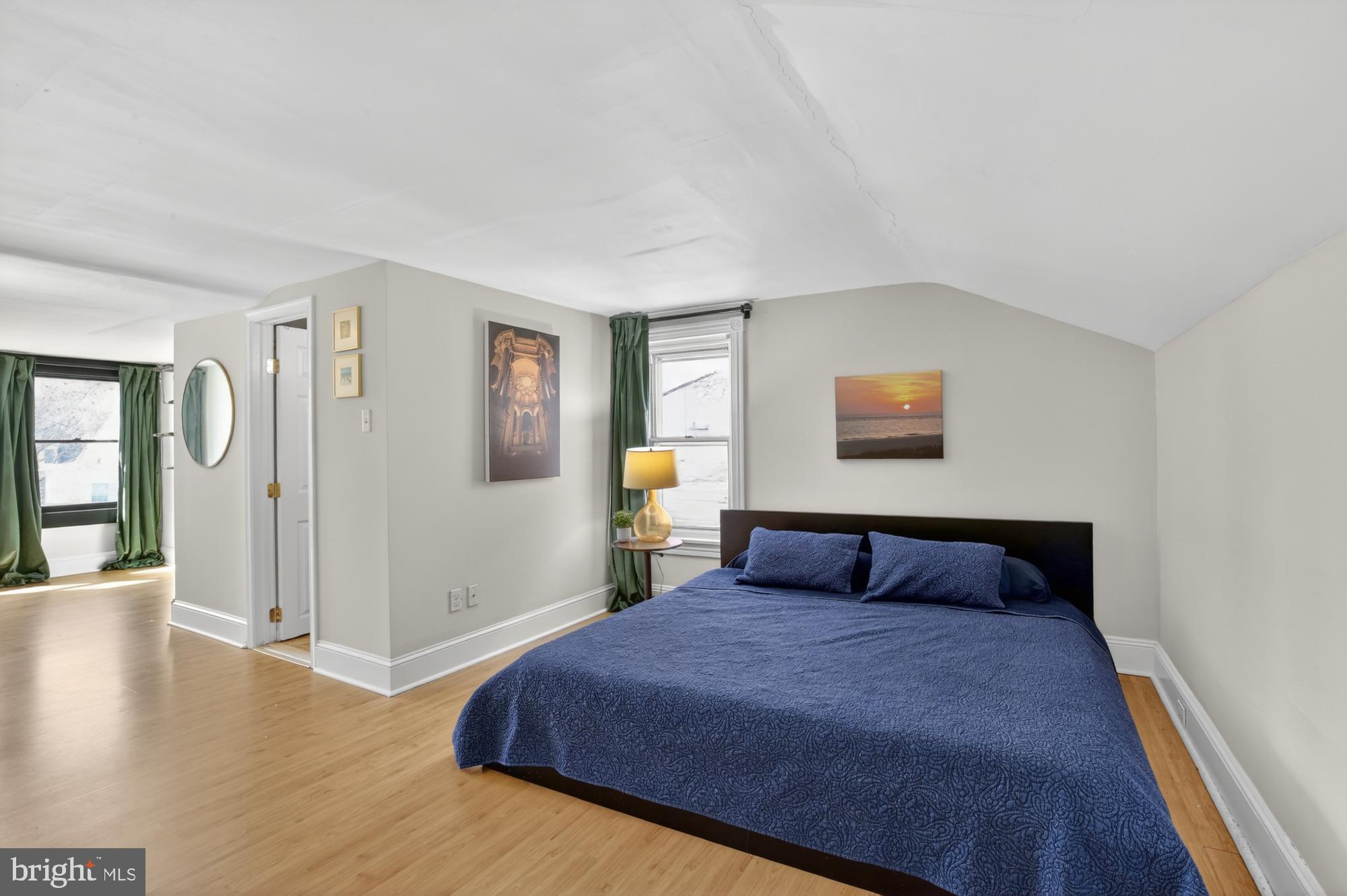 4315 Lauriston Street Philadelphia, PA 19128 - Photo 31 of 43 a bedroom with a large bed and wooden floor