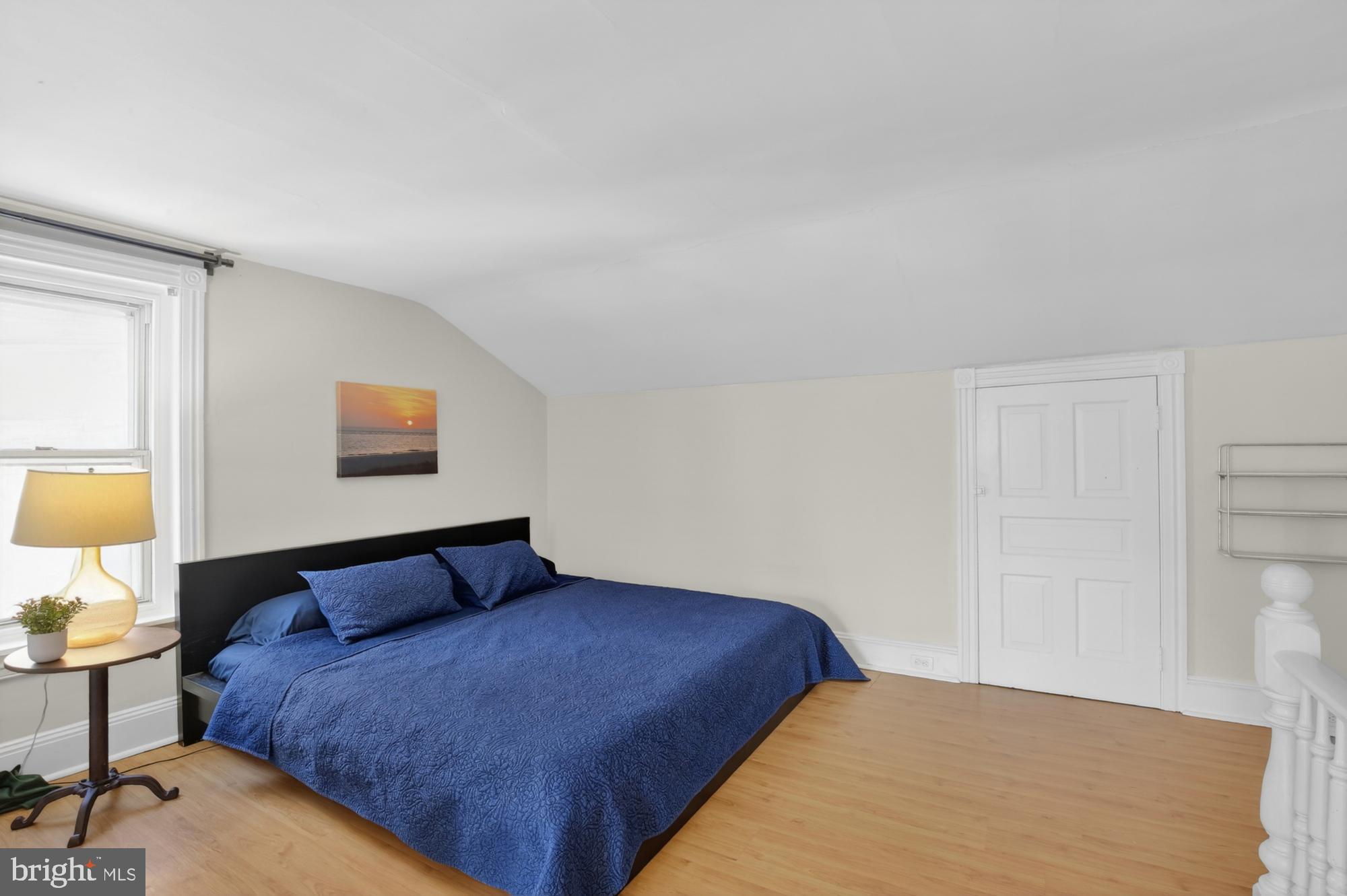4315 Lauriston Street Philadelphia, PA 19128 - Photo 32 of 43 a bedroom with a bed and a lamp on dresser