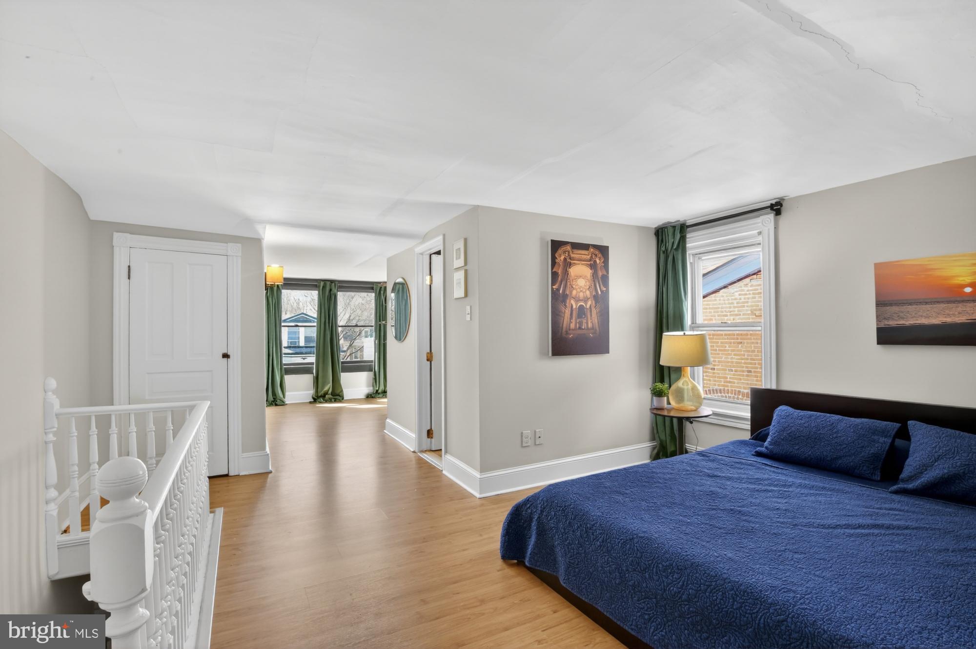 4315 Lauriston Street Philadelphia, PA 19128 - Photo 33 of 43 a bedroom with a large bed and wooden floor