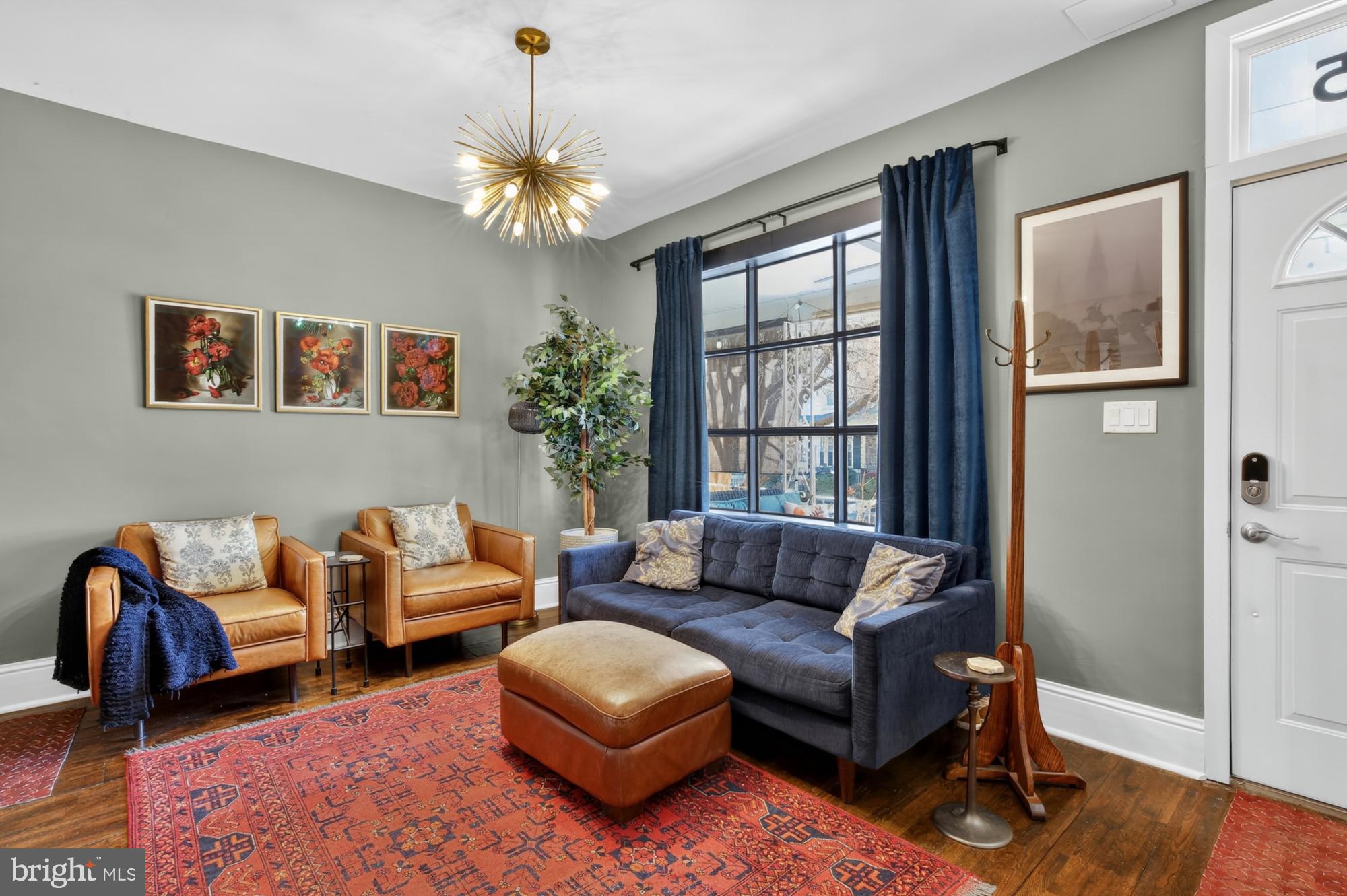 4315 Lauriston Street Philadelphia, PA 19128 - Photo 4 of 43 a living room with furniture and a chandelier