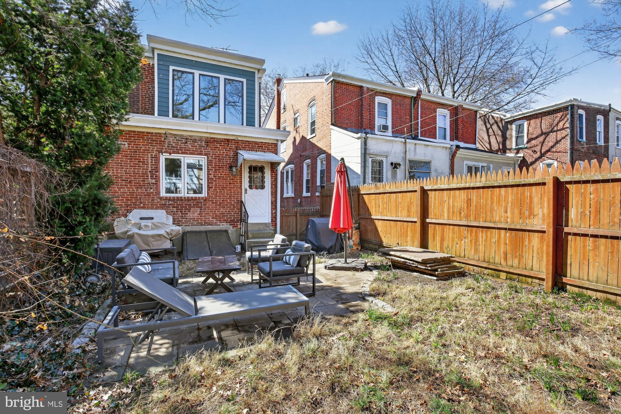 4315 Lauriston Street Philadelphia, PA 19128 - Photo 42 of 43 a backyard of a house with barbeque oven table and chairs
