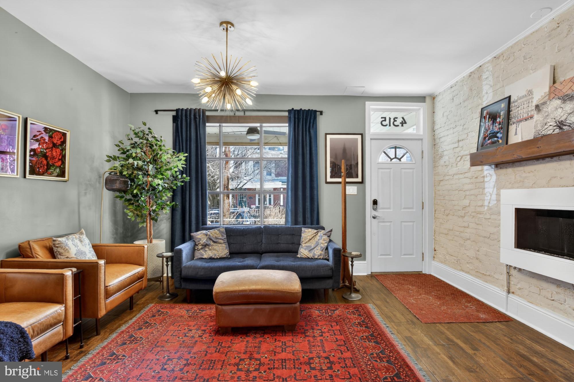 4315 Lauriston Street Philadelphia, PA 19128 - Photo 5 of 43 a living room with furniture a chandelier and a rug