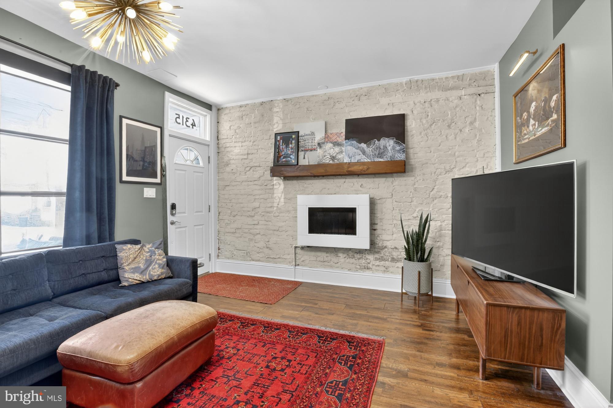 4315 Lauriston Street Philadelphia, PA 19128 - Photo 7 of 43 a living room with furniture and a flat screen tv