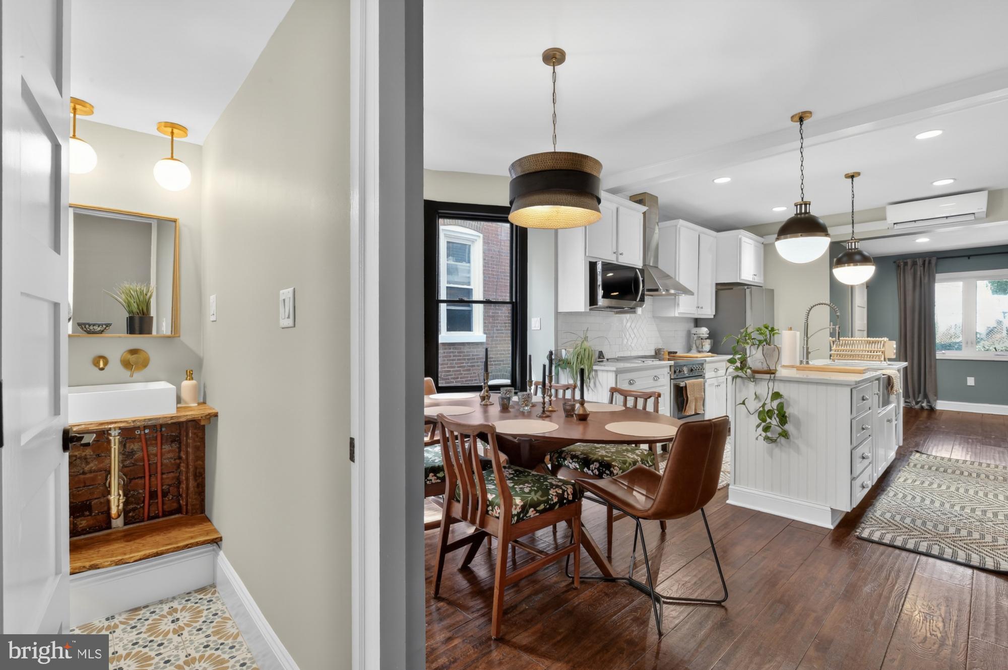 4315 Lauriston Street Philadelphia, PA 19128 - Photo 8 of 43 a view of a dining room and livingroom with furniture wooden floor a chandelier