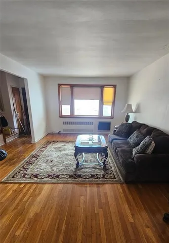 a living room with a couch and a rug