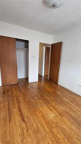 a view of an empty room and wooden floor
