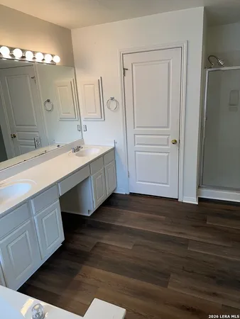 a bathroom with a double vanity sink and mirror