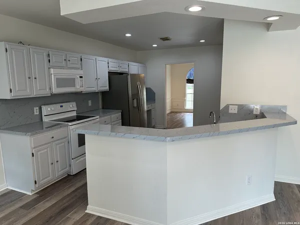 a kitchen with stainless steel appliances a refrigerator sink and cabinets