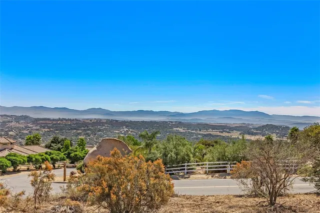 a view of ocean beach and mountain