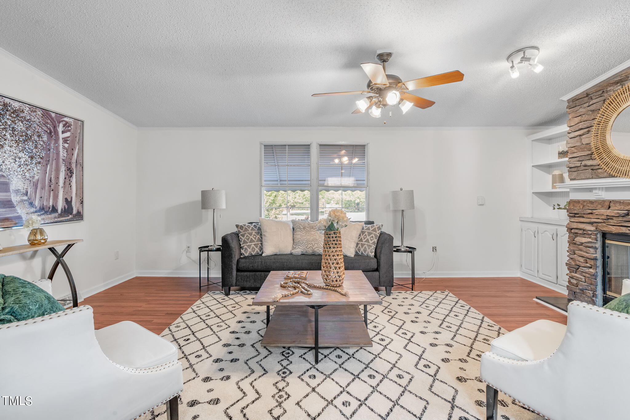 7844 Barbour Store Road Willow Spring, NC 27592 - Photo 20 of 40 a living room with fireplace furniture and a wooden floor