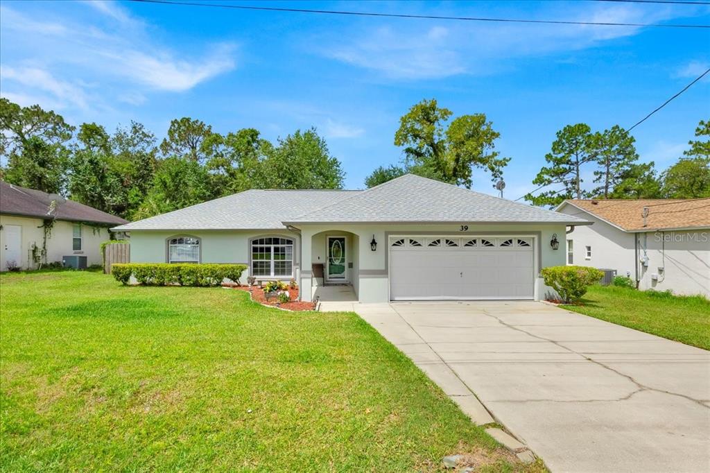 39 Pine Ct Drive Ocala, FL 34472 - Photo 1 of 1 a front view of a house with a yard and garage
