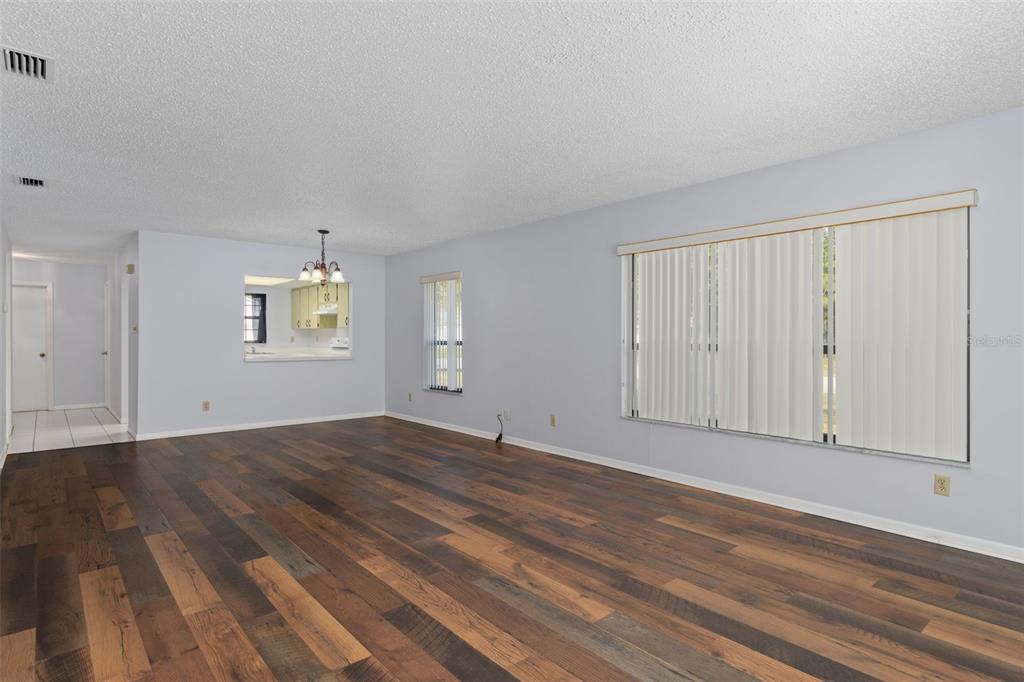 72 Chinaberry Circle Homosassa, FL 34446 - Photo 12 of 56 an empty room with wooden floor and windows