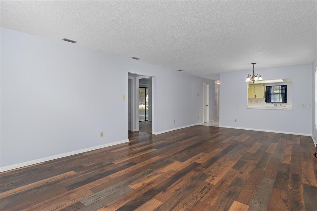 72 Chinaberry Circle Homosassa, FL 34446 - Photo 13 of 56 a view of an empty room with wooden floor and a window