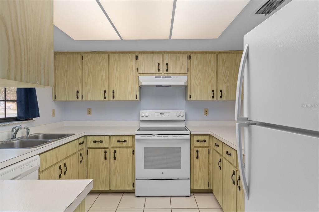 72 Chinaberry Circle Homosassa, FL 34446 - Photo 15 of 56 a kitchen with a stove top oven sink and cabinets