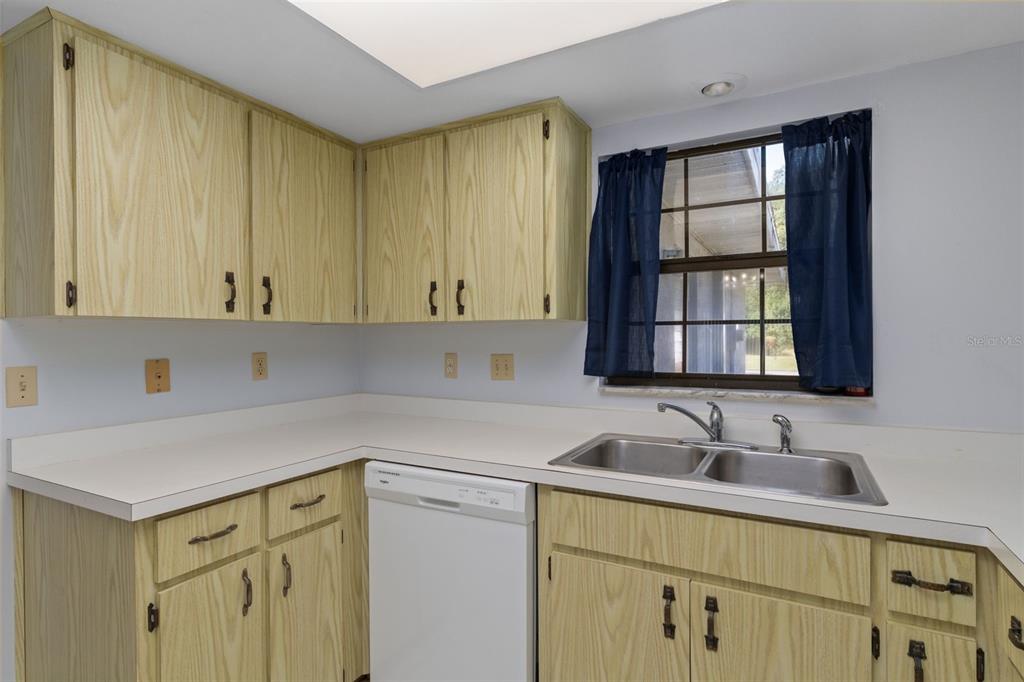 72 Chinaberry Circle Homosassa, FL 34446 - Photo 16 of 56 a kitchen with a sink cabinets and window