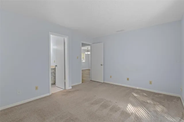 a bathroom with a granite countertop sink a toilet and a mirror