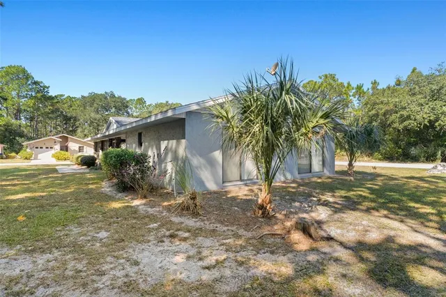 a view of a house with swimming pool and sitting area