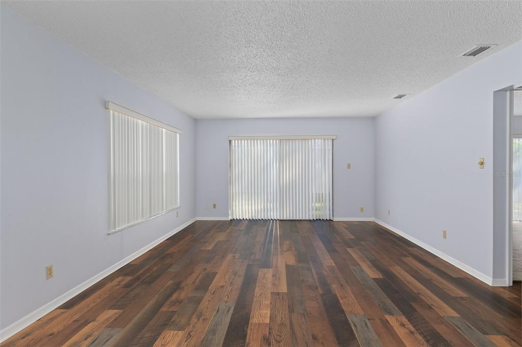 72 Chinaberry Circle Homosassa, FL 34446 - Photo 10 of 56 a view of an empty room with wooden floor and a window