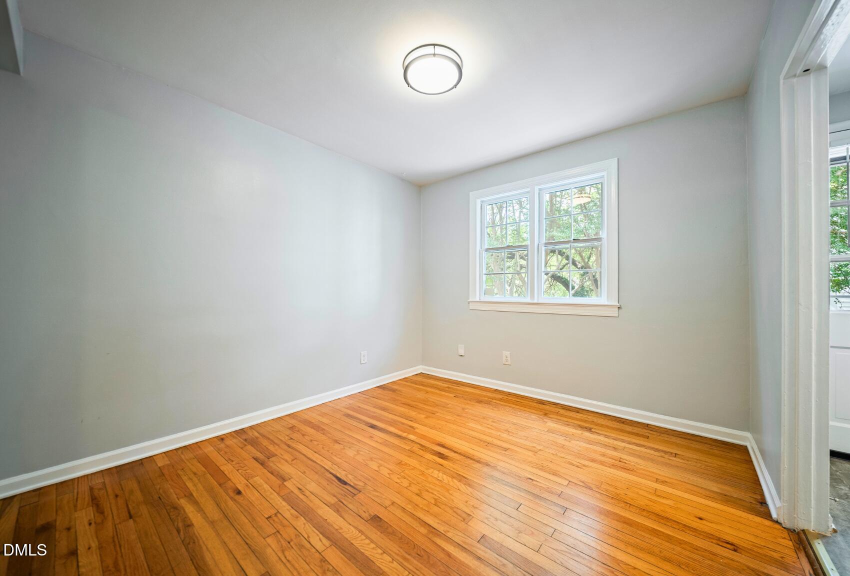 967 St Marys Street Raleigh, NC 27605 - Photo 15 of 34 an empty room with wooden floor and windows