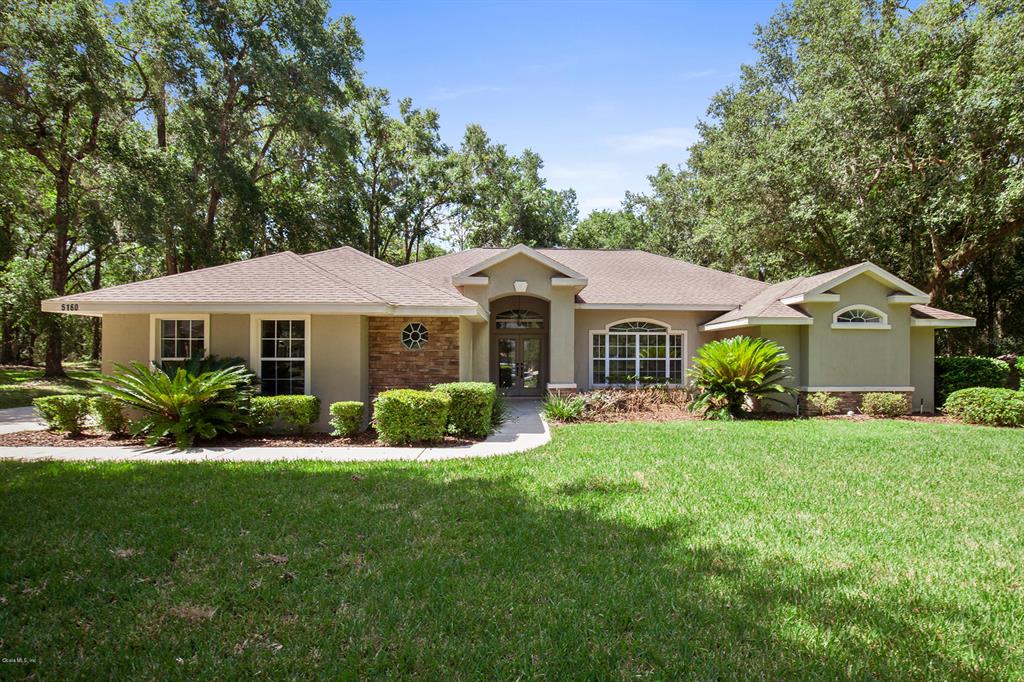 5160 Southeast 47th Ct Road Ocala, FL 34480 - Photo 1 of 1 a front view of a house with a yard porch and furniture
