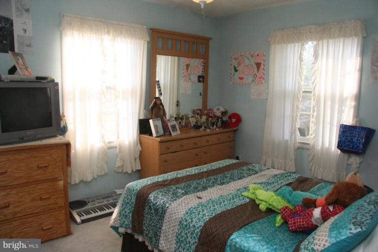 1702 Donald Place Silver Spring, MD 20902 - Photo 14 of 22 a bedroom with a bed and flat screen tv