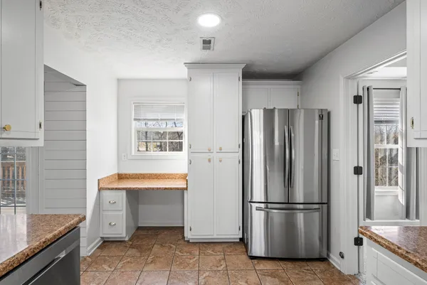 a kitchen with stainless steel appliances a refrigerator and a sink