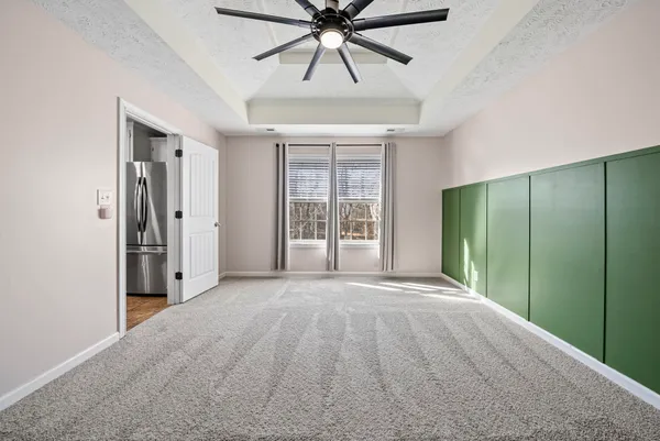en empty room with windows and fan
