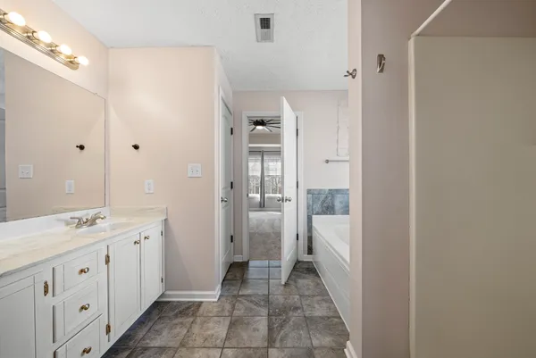 a bathroom with a double vanity sink and mirror