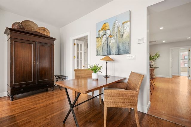 a dining room with furniture and wooden floor