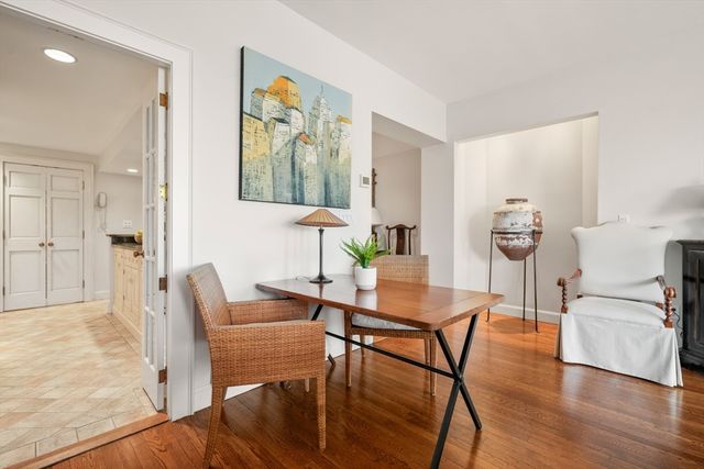a dining room with furniture and wooden floor