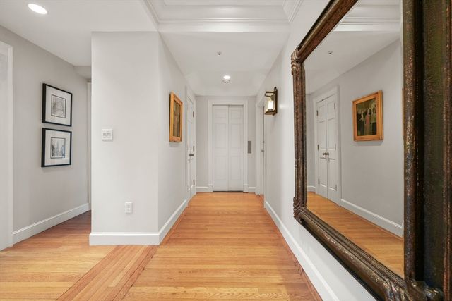 a view of a bathroom with mirror and shower