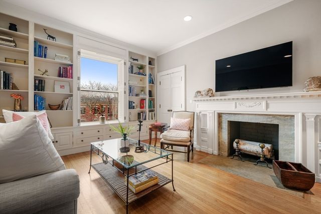 a living room with furniture fireplace and flat screen tv