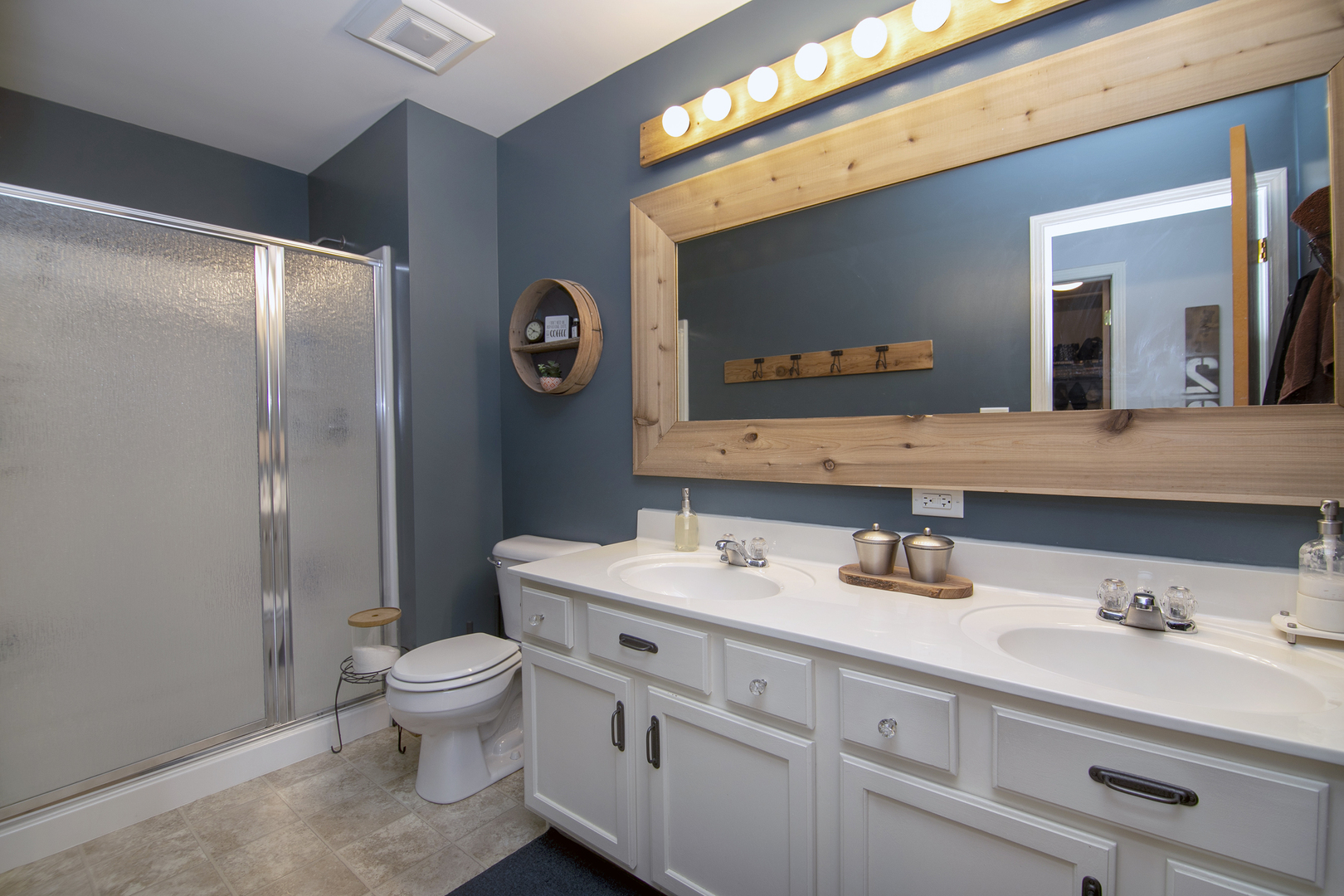 2256 Swallowtail Street Bourbonnais, IL 60914 - Photo 17 of 29 a bathroom with a toilet sink double vanity and mirror