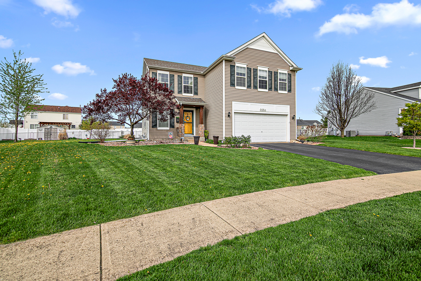 2256 Swallowtail Street Bourbonnais, IL 60914 - Photo 2 of 29 a front view of a house with a yard and garage