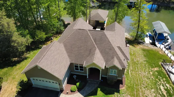 a view of house with swimming pool and outdoor seating