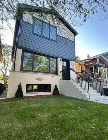 a front view of a house with a yard table and chairs