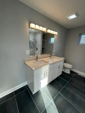 a room with a sink and a mirror