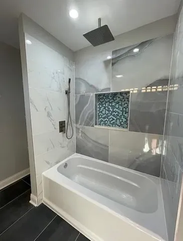 a bathroom with a bathtub and a shower