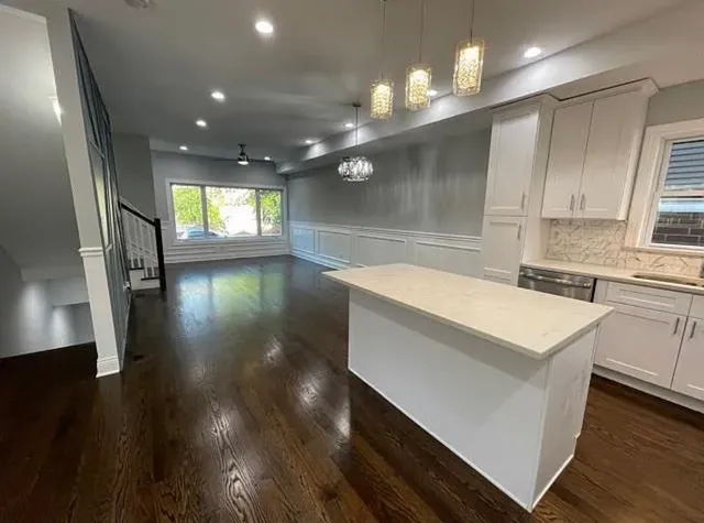 a kitchen with a sink and a stove top oven