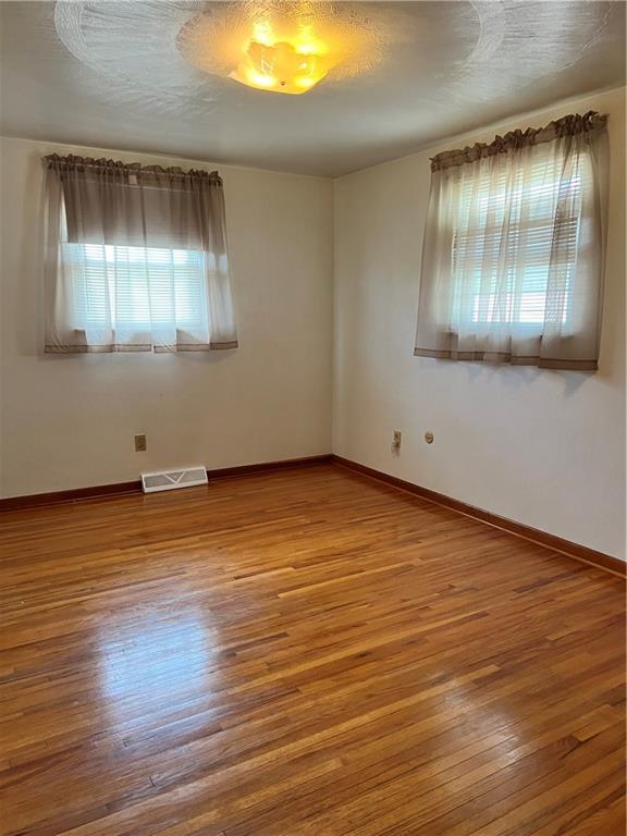 880 Pizza Barn Road Blairsville, PA 15717 - Photo 33 of 44 an empty room with wooden floor and windows