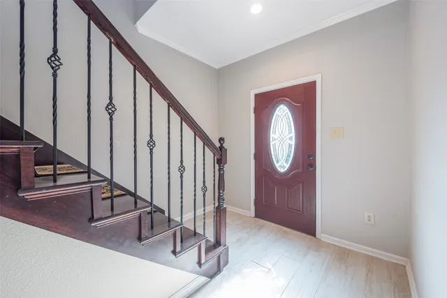 a view of an entryway with wooden floor