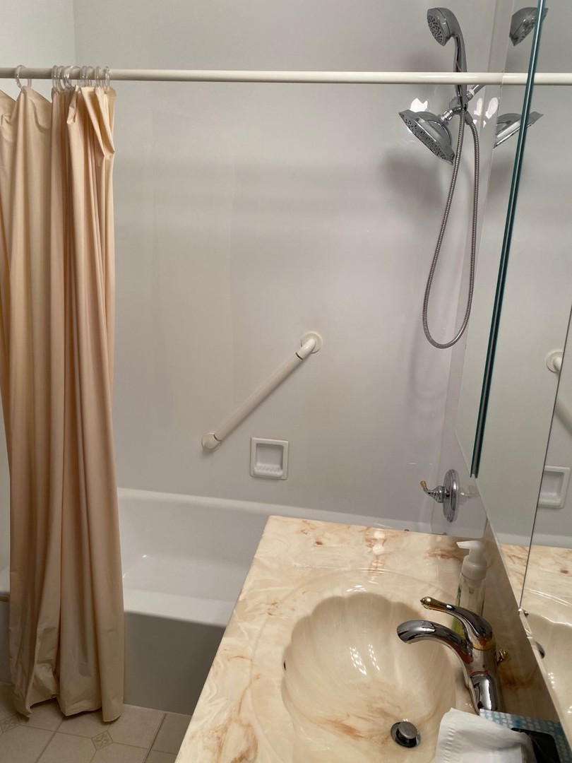 906 East Old Willow Road, Unit 104 Prospect Heights, IL 60070 - Photo 16 of 20 a bathroom with a sink and a tub
